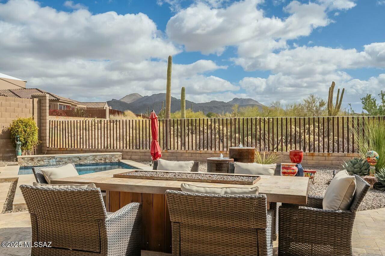 STUNNING Catalina, Saguaro, and Preserve Views! Enjoy exceptional active adult living on this one-of-a-kind premium homesite with a sparkling pool in Del Webb. The popular Pursuit model is loaded with upgrades including travertine entry and patio, engineered wood flooring, leathered granite countertops, high-profile baseboards, extended glass sliders, and a wet bar--perfect for entertaining. Sun Control awnings enhance the outdoor living space and backyard oasis. The chef's kitchen features double ovens, a gas cooktop, and abundant cabinetry. Washer/dryer included. Extended garage accommodates a golf cart plus air-conditioned storage. 2 bedrooms plus den (ideal guest or hobby space). Hot tub pad with electrical and water in place. A rare opportunity--call for a private showing!