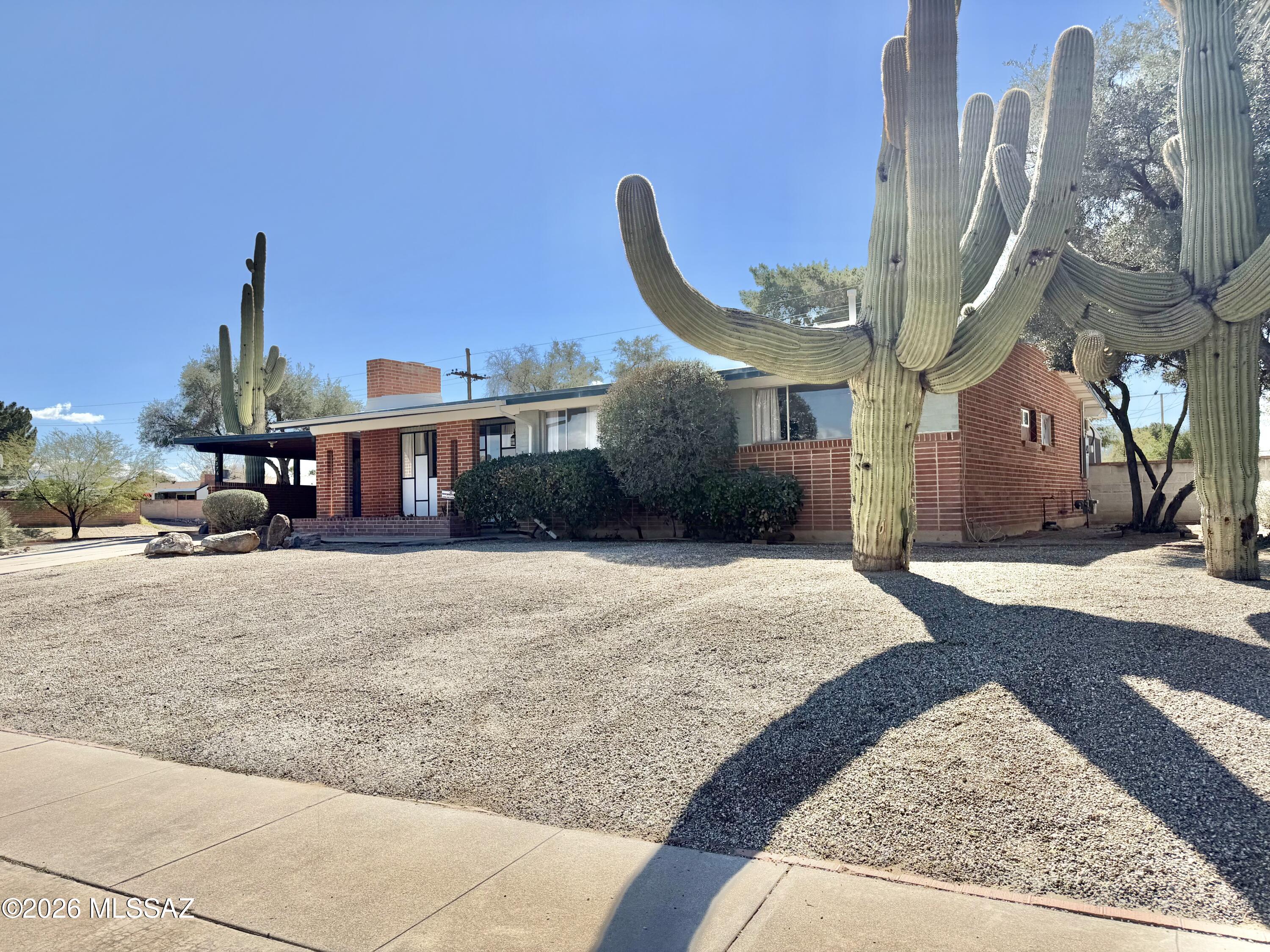 Seller will accept or counter offers between $299,000-$315,000. No HOA. Updated and move-in ready on Tucson's east side, this brick home offers a flexible 3BR layout or 2BR plus den with separate living, dining, and family-room spaces plus a cozy fireplace. Enjoy mountain views from the living room window, and step from the kitchen into the screened Arizona room for comfortable indoor-outdoor living. Recent improvements include new interior paint throughout and an updated secondary bathroom. Out back, the large shaded yard features mature trees and a shed/workshop, with a buffer and direct access backing to Jesse Owens Park. Noted updates include roof (2016), HVAC (2017), furnace (2017), and hot water heater (2021).