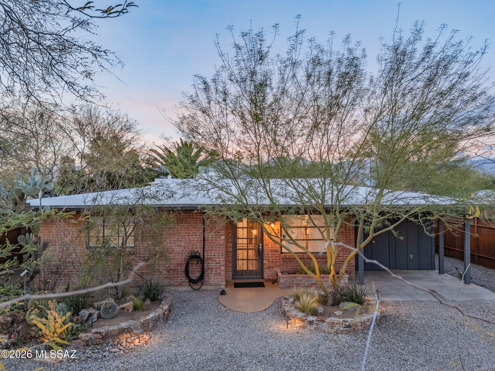 This desert modern bungalow shines in a centralized location with NO HOA! Full of character & heart, you will immediately feel right at home entering through the custom metal fencing. Inside, the newly refinished concrete floors pop, while the remodeled kitchen is not only aesthetic, but also adds functionality. The bedrooms are ample size and the large laundry room is perfect for storage. The backyard is an outdoor enthusiast's dream and features a large covered patio, peaceful gazebo, vegetable garden, a chicken coop, rain water cistern, and a turfed area. The possibilities are truly limitless. In addition, there is an outdoor shower and a workshop complete with electric. The lot orientation allows for stunning views of the mountains and sunsets. This unique property will not last long!