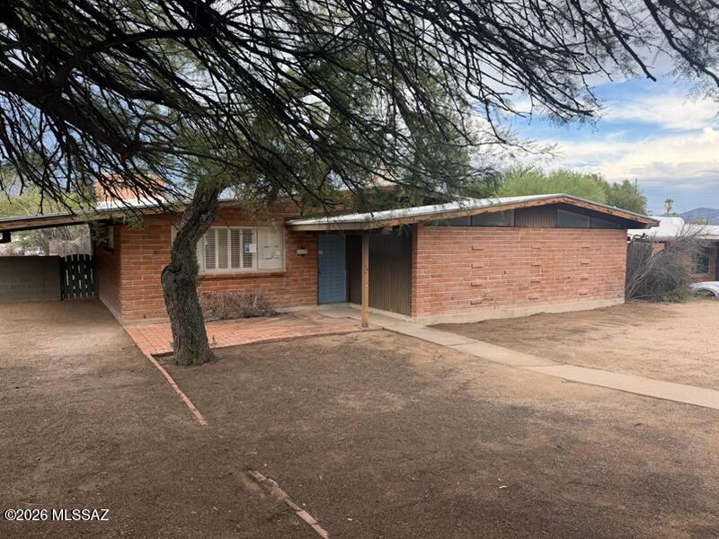 Discover a classic Tucson brick home with great bones and endless potential! This 3-bedroom, 2-bath single-story residence in Kingston Knolls Terrace offers 1,691 sq ft of living space ready for your vision. Featuring a spacious living room with a wood-burning fireplace, a kitchen with lots of counter space, breakfast bar, & a separate dining area. This home is a solid foundation for renovation or personalization. The property sits on a 0.19-acre lot with mature shrubs and trees, a covered patio, and block fencing for privacy. Conveniently located near Kolb and Speedway, close to schools, shopping, and parks. Bring your creativity--this home is ready to be transformed into something special!