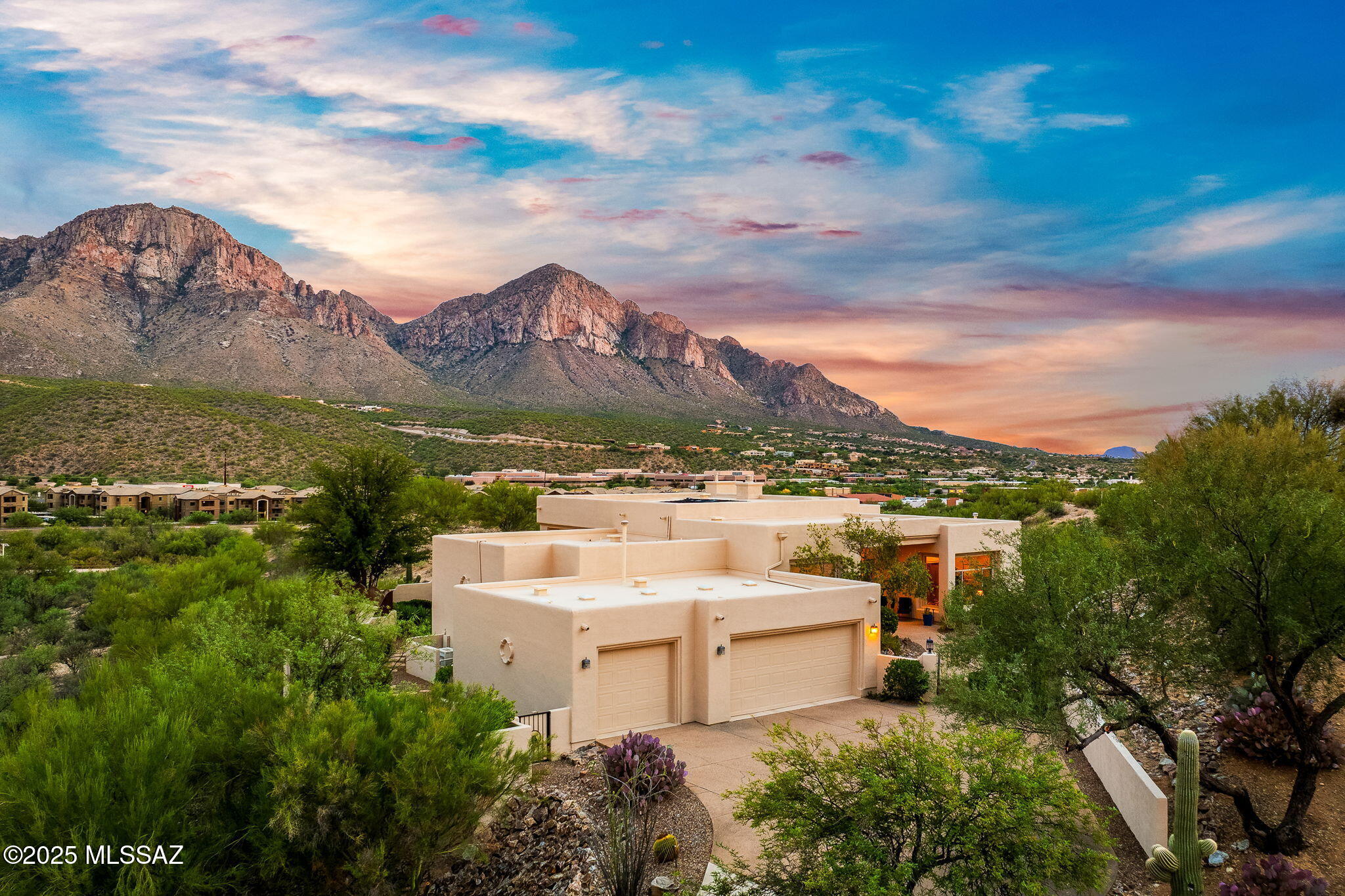 Welcome to your desert sanctuary! This 4-bed, 3-bath custom estate spans 3,282 sq ft on 2.68 private acres in a premier gated community and offers luxury, privacy, and sweeping Pusch Mountain views. The redesigned chef's kitchen with SS slate appliances, custom Alder cabinetry, and Dekton countertops flows into indoor/outdoor living spaces designed for entertaining. The large primary suite boasts soaring ceilings, a kiva fireplace, and spa-like bath. Outside, enjoy a heated resort-style pool and spa framed by desert beauty. There's plenty of seating areas to enjoy the view from both under the patio cover or on a turf area.  Enjoy the outdoor Kiva fireplace on cool evenings. The vacant lot next door is also for sale, creating a retreat of more than 5 acres in the heart of Oro Valley.