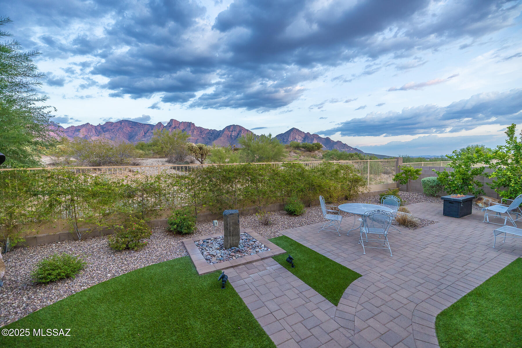 SWEEPING CATALINA MOUNTAIN VIEWS!!! Experience true Tucson living in this stunning 5 Bedroom, 3.5 Bath home tucked away on a private cul-de-sac in a gated Oro Valley community. With over 4,100 sq. ft. of living space, this home captures sweeping Catalina Mountain VIEWS & incredible Sunsets inside & out. Step into elegance with Great Room Downstairs & Loft/Family Room Upstairs, a spacious den/office, and an extended kitchen/dining area featuring a large island/breakfast bar, soft-close cabinets & drawers, pull-out shelves, granite countertops & stainless steel appliances. The downstairs primary suite offers mountain views, walk-in closet, and a spa-inspired bath with garden tub, walk-in shower, and dual vanities. Four additional bedrooms upstairs including three walk-in closets & two full baths with one Jack & Jill Bath. Two Laundry Rooms with Washers & Dryers included. Enjoy outdoor living at its finest with a rear covered patio, wall-mounted TV, natural gas BBQ & Hot Tub under a gazebo. Professionally designed landscaping, a Basalt fountain & gas fire pit. Two garages (one double, one single) with workbench & extra storage enhance the property's appeal. This is more than a homeit's a private retreat with breathtaking mountain views and modern amenities, designed for entertaining, relaxing, and everyday comfort. Call today for your private showing!