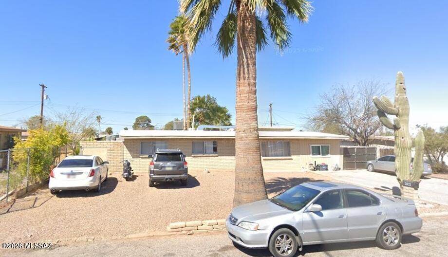 Welcome to this charming slump block home located in the heart of Central Tucson! This well-maintained 5-bedroom, 2-bath residence offers a spacious and functional floor plan featuring both a living room and family room, providing plenty of space for relaxing and entertaining. Inside, you'll find attractive laminate flooring throughout much of the home, complemented by Mexican tile flooring in the kitchen. The kitchen  cabinetry, mosaic tile countertops, and converted garage w/additional bedrooms. Step outside to a large backyard designed for Arizona living, complete with an in-ground swimming pool and plenty of room for gatherings, gardening, or recreation. The property also offers abundant space for vehicles, trailers, and recreational toys with a convenient RV gate.