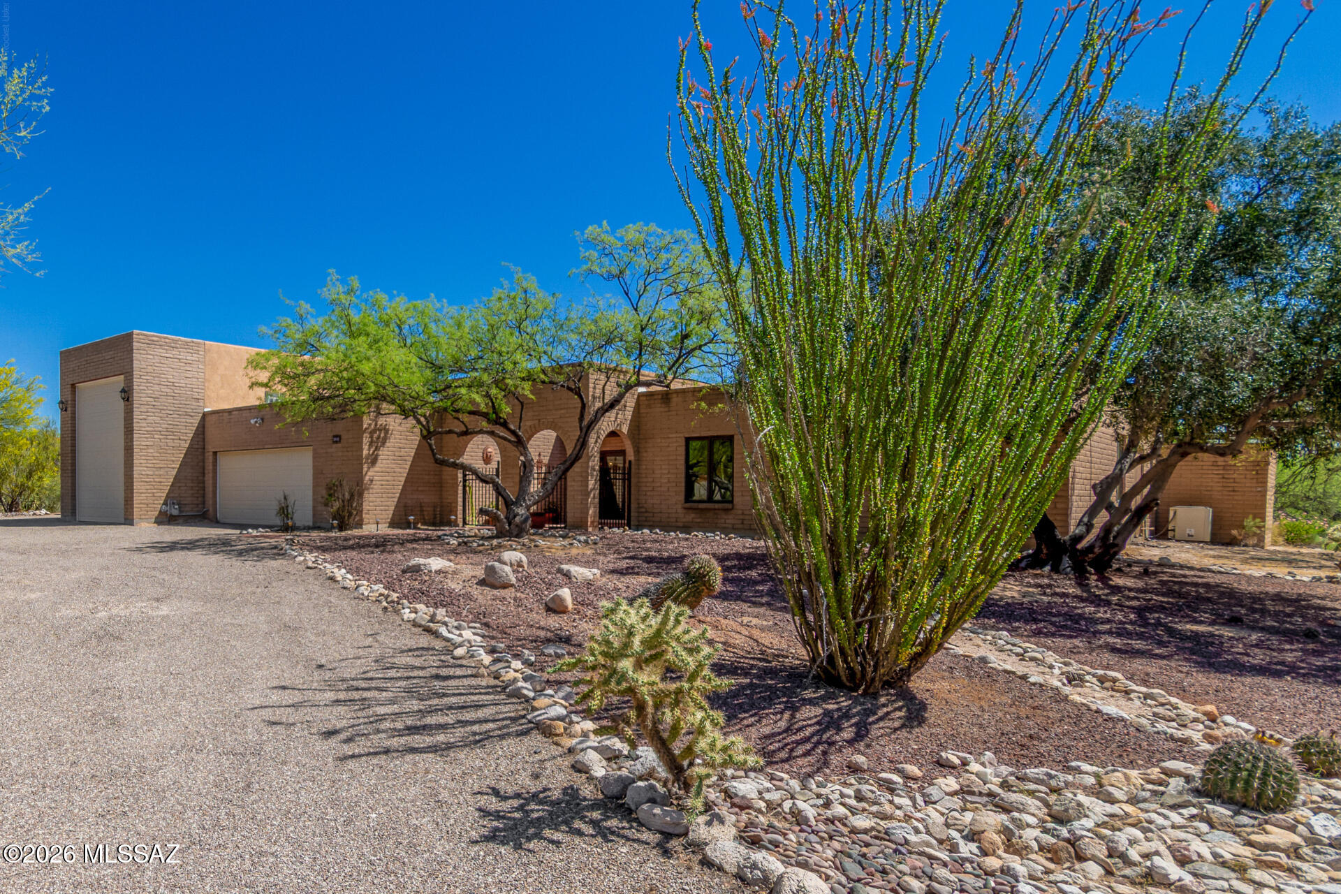 Exceptional desert retreat set on a wide-open 1.086-acre lot with a gorgeous backyard and a sparkling pool, enclosed in natural Sonoran beauty and timeless Southwestern charm. A circular drive welcomes you home, with plenty of room for all your rigs-featuring 2,766 sq ft, 5-bedrooms, 2.5 bathrooms, interior courtyard, 2-car garage, and a dedicated full-size RV garage. Step through the inviting courtyard and feel the warm, relaxed welcoming atmosphere. 

This thoughtfully laid-out floor plan blends comfort with character- soft carpeting in the living room, graceful arched doorways, and sunlight pouring in through expansive multi-sliding doors that give you the indoor/outdoor feel. You'll find a formal dining space, a convenient powder room, and a family room anchored by a gas fireplace and a built-in bookcase- making this space for evening gatherings. Throughout the home, a harmonious mix of ceramic and Sillito tile enhances its distinctive Southwestern appeal.

The kitchen is the heart of the home, designed for both function and flair, with a central prep island, tile countertops and backsplash, built-in appliances, and rich wood cabinetry that adds a rustic touch, recessed lighting and a cabinet pantry. There is a separate breakfast area located near glass doors and a picture-perfect view of the backyard. 

The primary bedroom serves as a true desert sanctuary, featuring private access to the backyard, two spacious closets, and plush carpeting for added comfort. The ensuite bathroom is thoughtfully designed with dual vanities, a mirrored closet, and a tiled walk-in shower from floor to ceiling. Sliding doors lead to a secluded patio--an ideal spot to enjoy peaceful mornings beneath desert skies.

The additional bedrooms are generously sized and also feature soft carpeting, sharing a well-appointed hallway bathroom with shower/tub combo. With multiple bedrooms available, the home offers excellent flexibility to accommodate a home office, fitness space, or other lifestyle needs.

The backyard is a desert oasis beginning with a screened-in concrete patio with dual ceiling fans lets you enjoy the outdoors year-round, while the yard continues the natural desert vibe with a unforgettable blue pool! 

Homes like this don't last long- come claim your slice of the Southwest before it's gone.