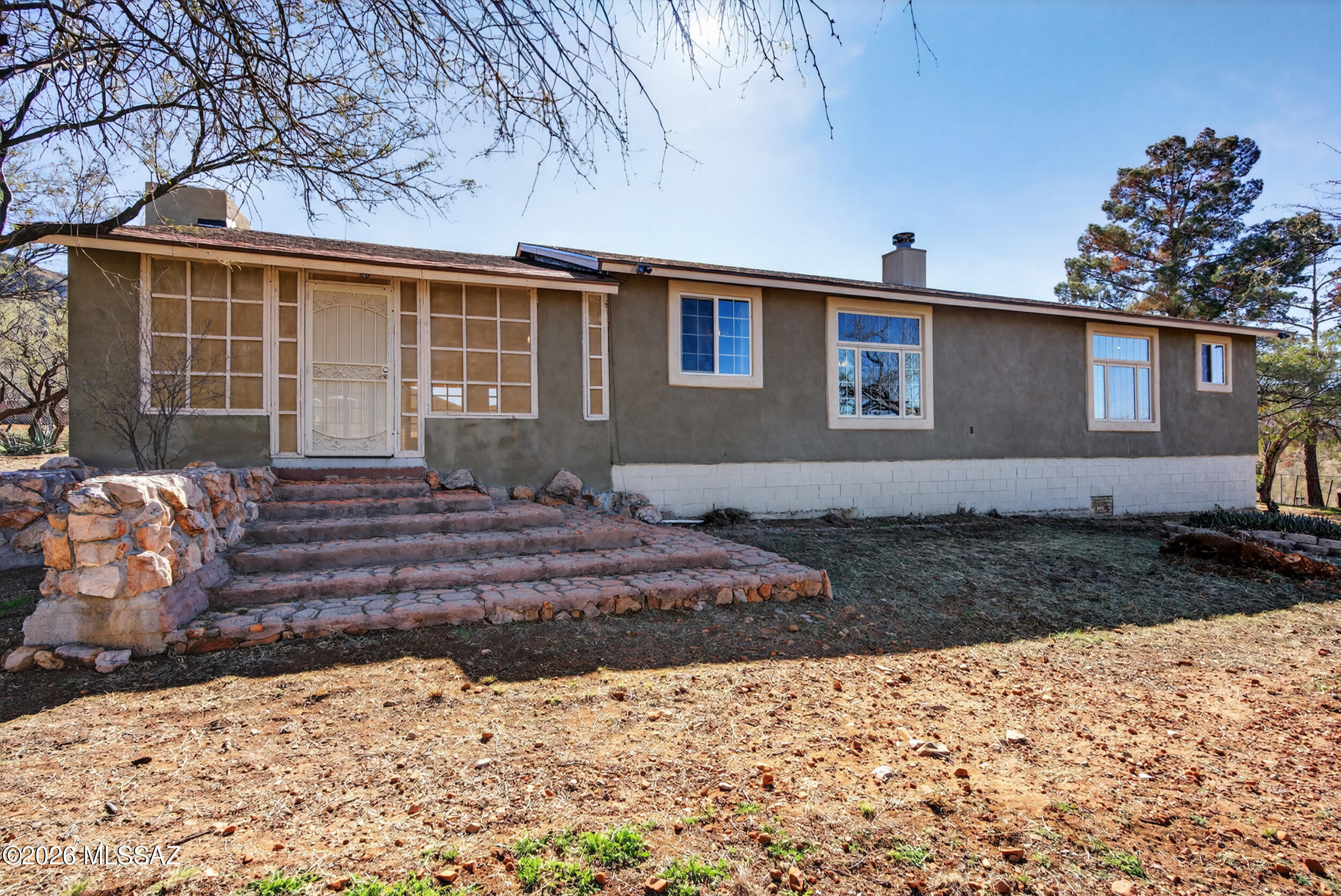Seller will accept/counter offers between $450k-$475k.  Amazing 5 Acre Homestead located in the Santa Rita Foothills! Bright and Spacious remodeled home featuring an open feeling 3bed/2bath floor plan. Beautiful kitchen with island overlooking living room and dining area. Large living room with picturesque windows and cozy fireplace. Huge primary suite with walk in closet, spacious bath with double vanity and freestanding shower/tub. Awesome 2 story garage/workshop perfect for the car enthusiast and upper level heated/cooled hobby rooms. Perfect for a potential guest house! Room for all the toys and concrete pad for RV. Outstanding peace and tranquility with 360 views! Brand New Roof with warranty. TEP Solar Panels for a LOW fixed monthly payment. Must see!