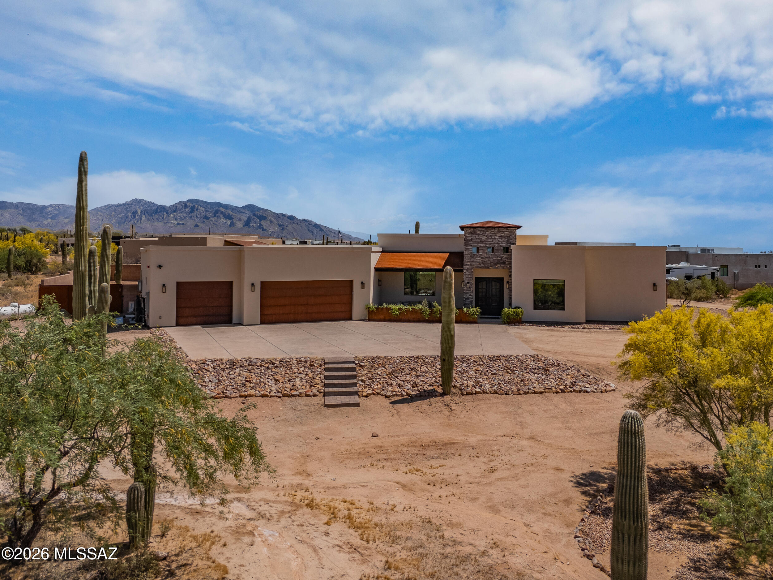 Beautifully situated on 1.8 acres of pristine Sonoran Desert, this like-new 2023 luxury custom home offers beauty, privacy, and NO HOA. Designed with 4 spacious bedrooms, 3.5 baths, a den, and an oversized 3-car garage. A gourmet kitchen features a gas range, expansive island, butler's pantry all opening to a stunning dining area with a wine and beverage fridge. The spa-like primary suite includes a large walk-in shower & elegant soaking tub. A bonus room with A/C is perfect for a home gym, shop, or creative space. Step outside to enjoy an extended covered patio, artificial turf, paver patio w/ fire pit, and beautiful mountain & sunset views, all from an enclosed pool size yard--truly a peaceful desert retreat. On 1.8 acres, there is ample space for a casita, RV garage, or horse facilities