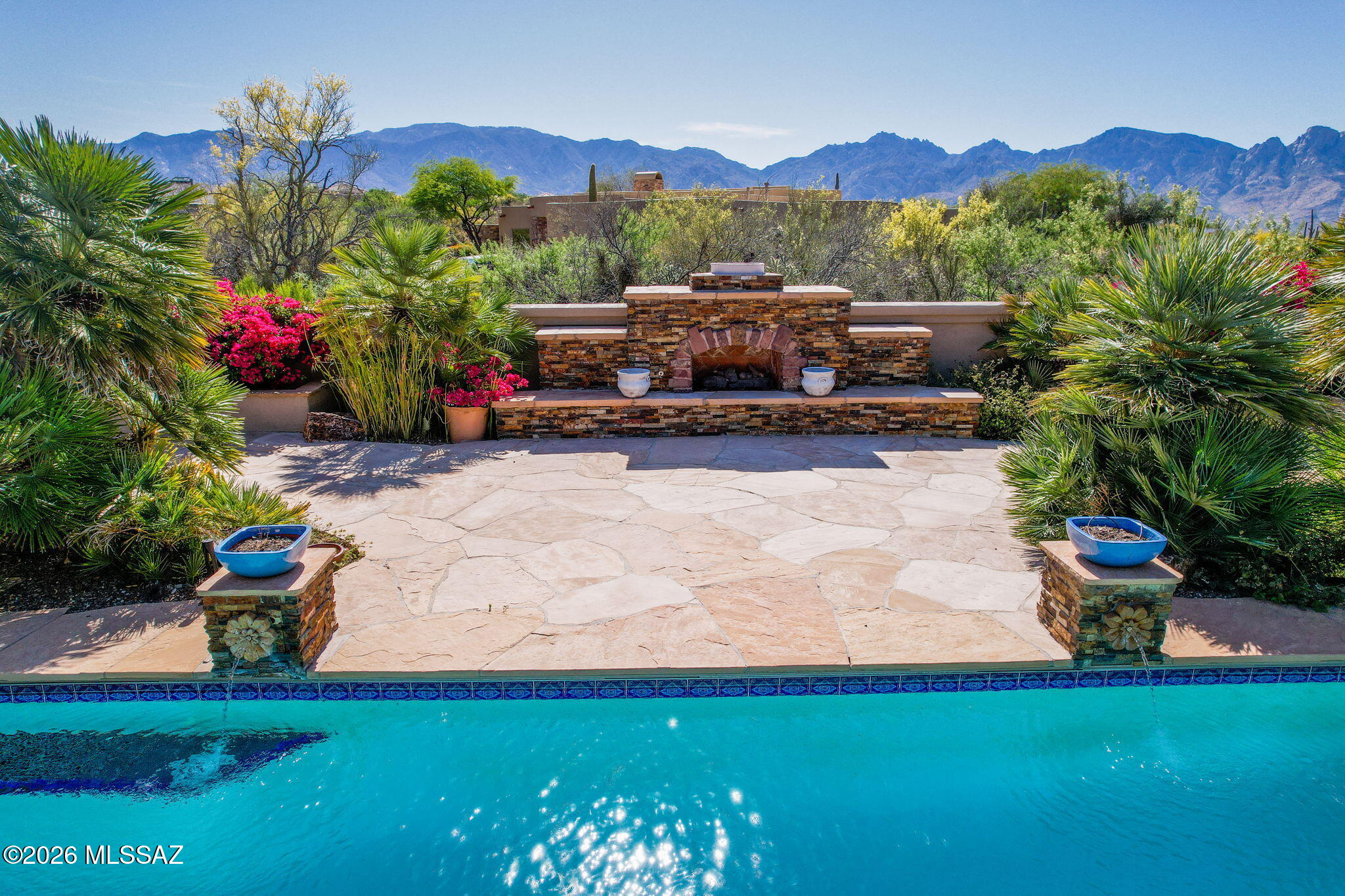 Luxury living at its finest. This property sits back from the street and allows significant privacy on it's over 1 acre parcel. The neighborhood is guard-gated for additional security and exclusivity. In the rear of the home you will find a pool, spa, top of the line outdoor kitchen, a fireplace, and incomparable views of Pusch Ridge. Inside, this home boasts two large family areas, two dining areas,and a split design for guests. High ceilings make this over 4300 sq ft home feel even more grand. For wine lovers, a wine room is off the kitchen. The oversized 3 car garage as well as ample closet space ensure that there is room for everything you own. A turf covered dog run ensures no member of the family was not considered. This home has everything you could want and more.