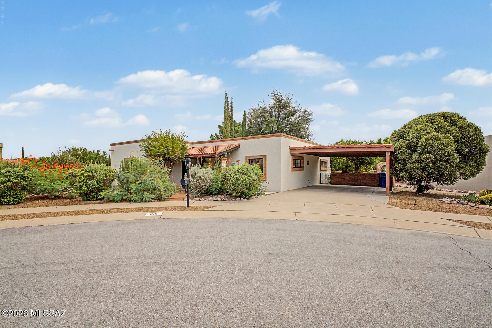 This beautiful, semi-custom home blends light, airy living with classic Southwestern charm. This unique home features a spacious living area with an authentic beehive fireplace, a dedicated library with walls of built-in bookshelves, and last but not least, an inspiring artist studio that is flooded with natural light for a calming creative haven. The generous primary suite boasts a standing tiled shower, a generous walk-in closet, and a private slider leading out to the rear patio and backyard. Situated on a large cul-de-sac lot framed by lush natural greenery, this home provides abundant open space, a large attached storage room, peaceful privacy, and effortless indoor-outdoor desert living. This GVR home is one of a kind and ready for it's next owner to make it their own.