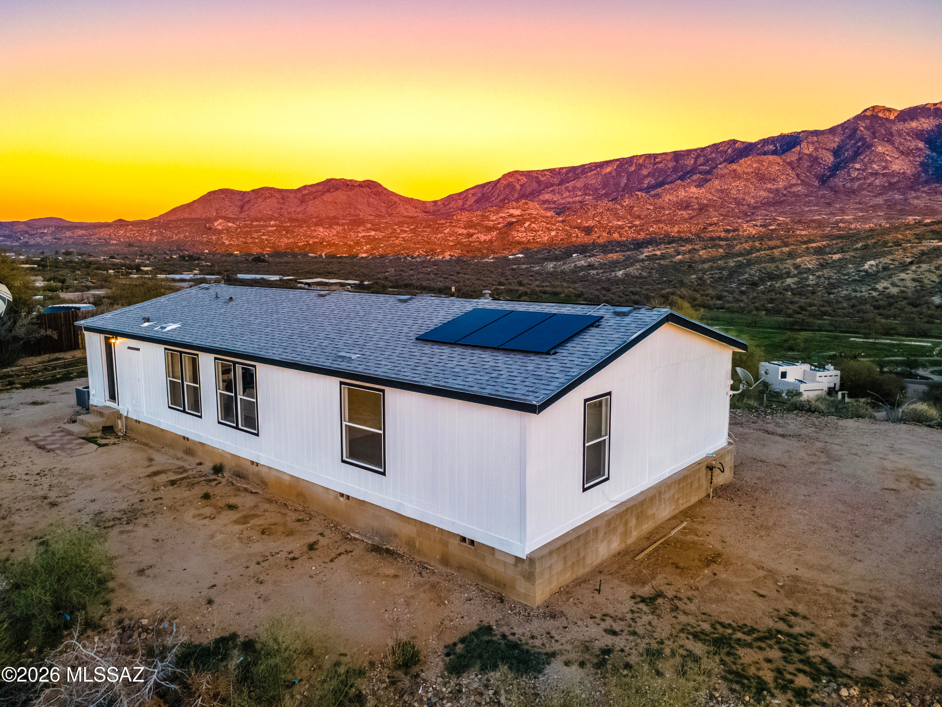MOTIVATED SELLER! Enjoy space, privacy, and beautiful mountain views on this updated 1-acre property. This 3-bedroom, 2-bath manufactured home offers 1,568 sq. ft. of comfortable living space with fresh interior and exterior paint and a bright, inviting feel throughout. The open-concept floor plan features vaulted ceilings, wood-look flooring, and a neutral color palette that makes the home easy to personalize. The well-appointed kitchen offers white cabinetry, a pantry, and a center island with breakfast bar seating, creating a functional space for both everyday living and entertaining. The spacious primary suite includes plush carpeting, a walk-in closet, and a private en-suite bath. Solar panels add energy-efficient benefits and the potential for long-term utility savings. Owner/Agent