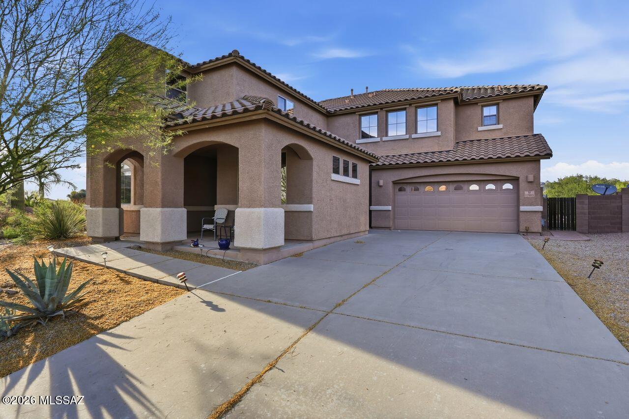 Range priced $690,000-$720,000, this Northwest home in gated Tangerine Crossings offers space, privacy, and a premium lot with no rear neighbors. Featuring 5 bedrooms and 5 bathrooms, four bedrooms include walk-in closets for added convenience and storage. The open kitchen features quartz countertops, pull-out cabinetry, and flows into inviting living areas. The primary suite offers a sitting area, separate vanities, soaking tub, separate shower, and access to an oversized deck with mountain and sunset views. Backyard features desert landscaping, drip irrigation, and a heated, self-cleaning Pebble Tec pool with a color-changing light with remote. Additional highlights include leased solar, dual A/C, water softener, surround sound, fire sprinklers, EV charging, and a tandem 4-bay garage.