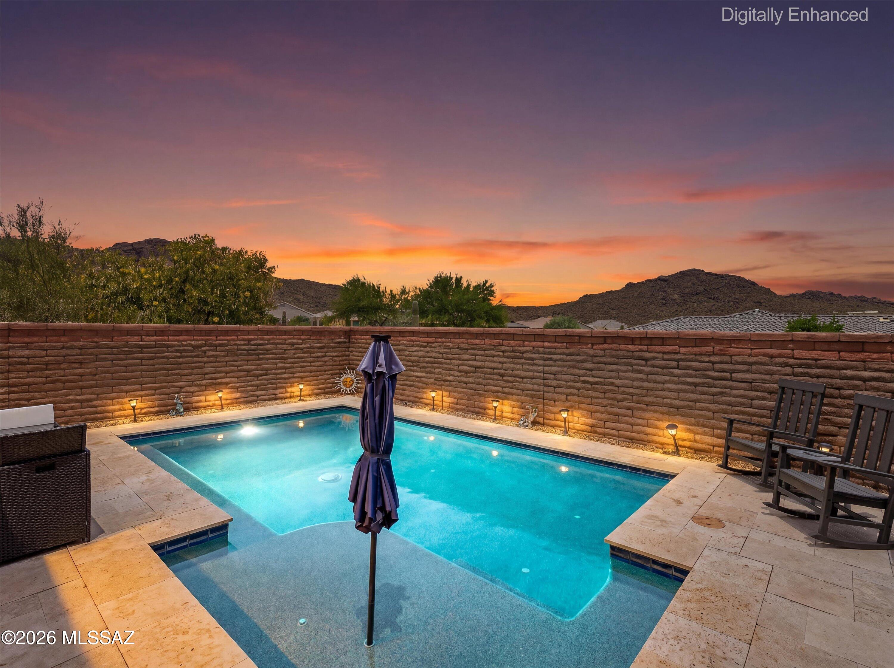 Welcome to one of Lazy K's most coveted homes, perfectly positioned at the top of the street with commanding mountain views & unmatched privacy. With 1 side & NO rear neighbors, this exceptional property offers a peaceful retreat while showcasing stunning desert sunsets from both the front & back of the home. The resort-inspired backyard features a sparkling pool, travertine decking, lush turf, & a charming outdoor fireplace designed for year-round entertaining.

Inside, the thoughtfully designed split floor plan offers both comfort & flexibility, featuring a media room & a versatile space that can serve as a 4th bedroom, home office, or den. 

Extensive upgrades throughout enhance the home's style and functionality, creating a move-in-ready opportunity!