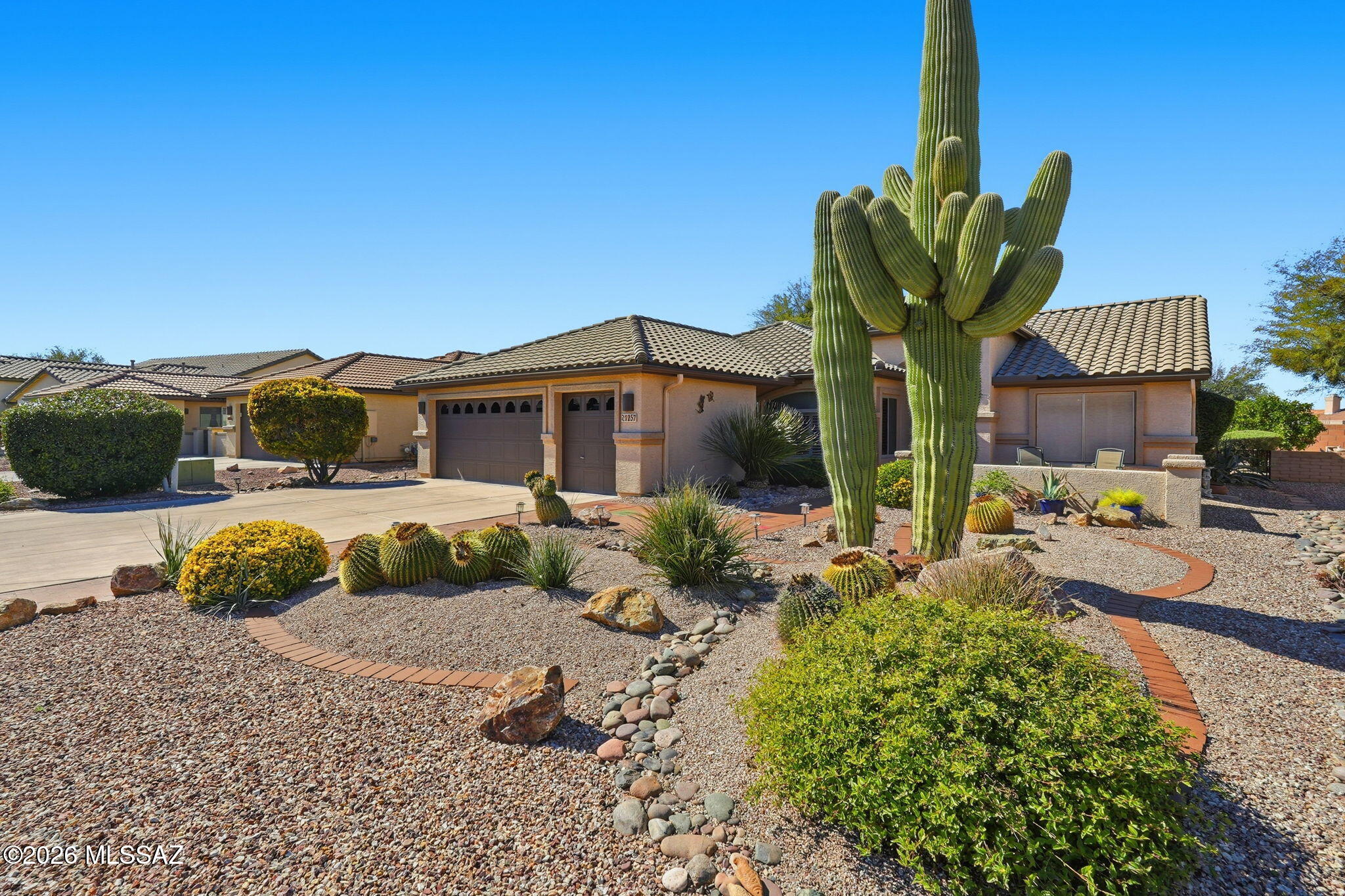 Beautifully maintained Laredo model in the popular active adult Robson community of Quail Creek. This 2 bedroom, 2 bathroom home with a versatile den is being offered fully furnished, making it truly turn-key ready for you to enjoy! Inside you'll find an open and welcoming floor plan, a bright kitchen featuring a center island, stainless steel appliances, quartz countertops and a sunny dining nook. Spacious bedrooms and bathrooms. Large laundry room with cabinets and counter space. The oversized 2½-car garage has room for your golf cart plus additional storage. Enjoy the Arizona sun while sitting in the charming front courtyard or the peaceful screened-in tiled back patio that overlooks the mature backyard landscaping and built-in BBQ. HVAC was replaced in 2024, giving you added peace of mind. Quail Creek residents enjoy amazing resort-style amenities including an outdoor pool, a new clubhouse with indoor pool, fitness center with mountain views, pickleball and tennis courts, golf, social events and clubs, on-site restaurant and lounge, secure 24-hour guarded gated entrance and so much more! Ideal as your full-time residence or a winter retreat.