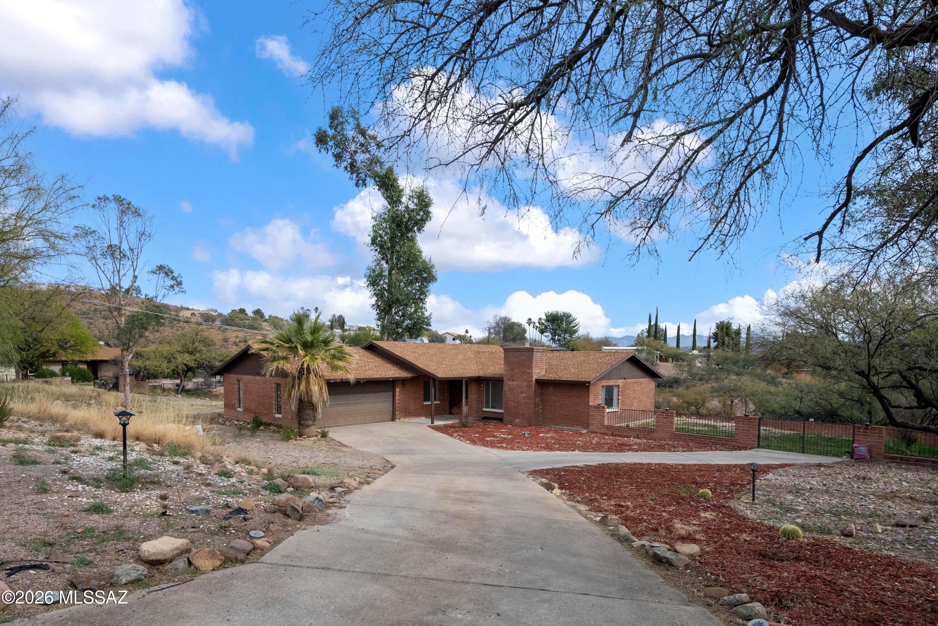 Location is everything, and this solid brick home delivers. Featuring a concrete driveway and two-car garage, the home offers formal living and dining areas, a spacious family room, and a breakfast nook ideal for everyday living. With three bedrooms and two bathrooms, the layout is both functional and comfortable. Situated on an expansive .43-acre lot, the covered patio opens to a backyard enclosed with block and wrought iron fencing—providing endless possibilities to create the outdoor space of your dreams. A rare opportunity with space, structure, and location. Show and sell!