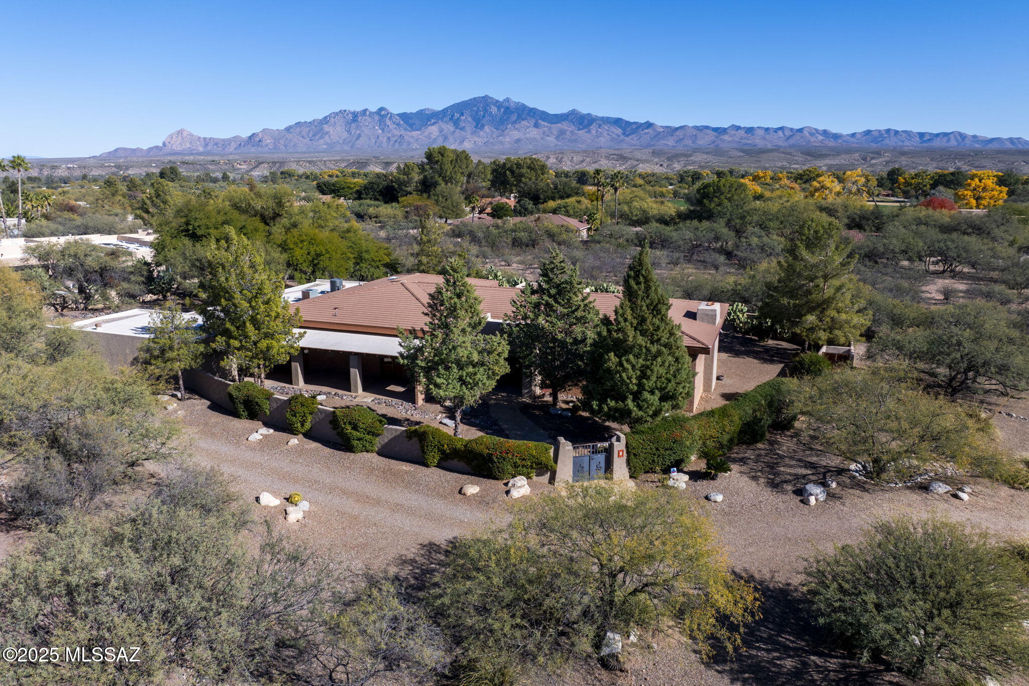 Welcome to this impeccably maintained home located in the beautiful and tranquil Tubac Country Club Estates. From the moment you arrive, you are greeted by a charming gated courtyard and welcoming entryway that set the tone for the comfort and quality found throughout the home.

Step inside to an open and spacious living room featuring high ceilings with striking overhead beams, recessed lighting, and large neutral tile floors that create a bright and airy atmosphere. A cozy fireplace anchors the space, while a sunken bar adds a perfect spot for entertaining and gathering with friends and family.

SEE MORE.. The open kitchen is both functional and inviting, highlighted by a large picture window over the sink that frames serene views of the patio and surrounding mountains, allowing natural light and nature to flow in. The kitchen boasts gorgeous granite countertops, a large butcher block island ideal for meal prep or casual dining, and a generous pantry providing ample storage. Adjacent to the kitchen, the dining area sits comfortably between the kitchen and great room, accented by a beautiful chandelier and offering an ideal space to enjoy everyday meals or special occasions.

Throughout the home, tasteful Southwestern touches add warmth and character, including colorful tiled bathrooms that bring charm and personality to the living spaces. Every area of the home reflects pride of ownership and thoughtful care, showcasing its impeccable maintenance.

The private, fully enclosed backyard is a true retreat. With mountain views and peaceful surroundings, it offers a beautiful setting to relax, entertain, or simply enjoy the outdoor lifestyle Arizona is known for. Whether sipping your morning coffee or enjoying an evening under the stars, this space provides serenity and privacy.

Car enthusiasts and hobbyists will appreciate the expansive 7-car garage, offering abundant room for vehicles, storage, and toys alike.

This exceptional home combines comfort, style, and functionality in one of Tubac's most desirable and quiet neighborhoods. Experience Arizona living at its best in a residence that has been lovingly cared for and is ready to welcome its next owner.