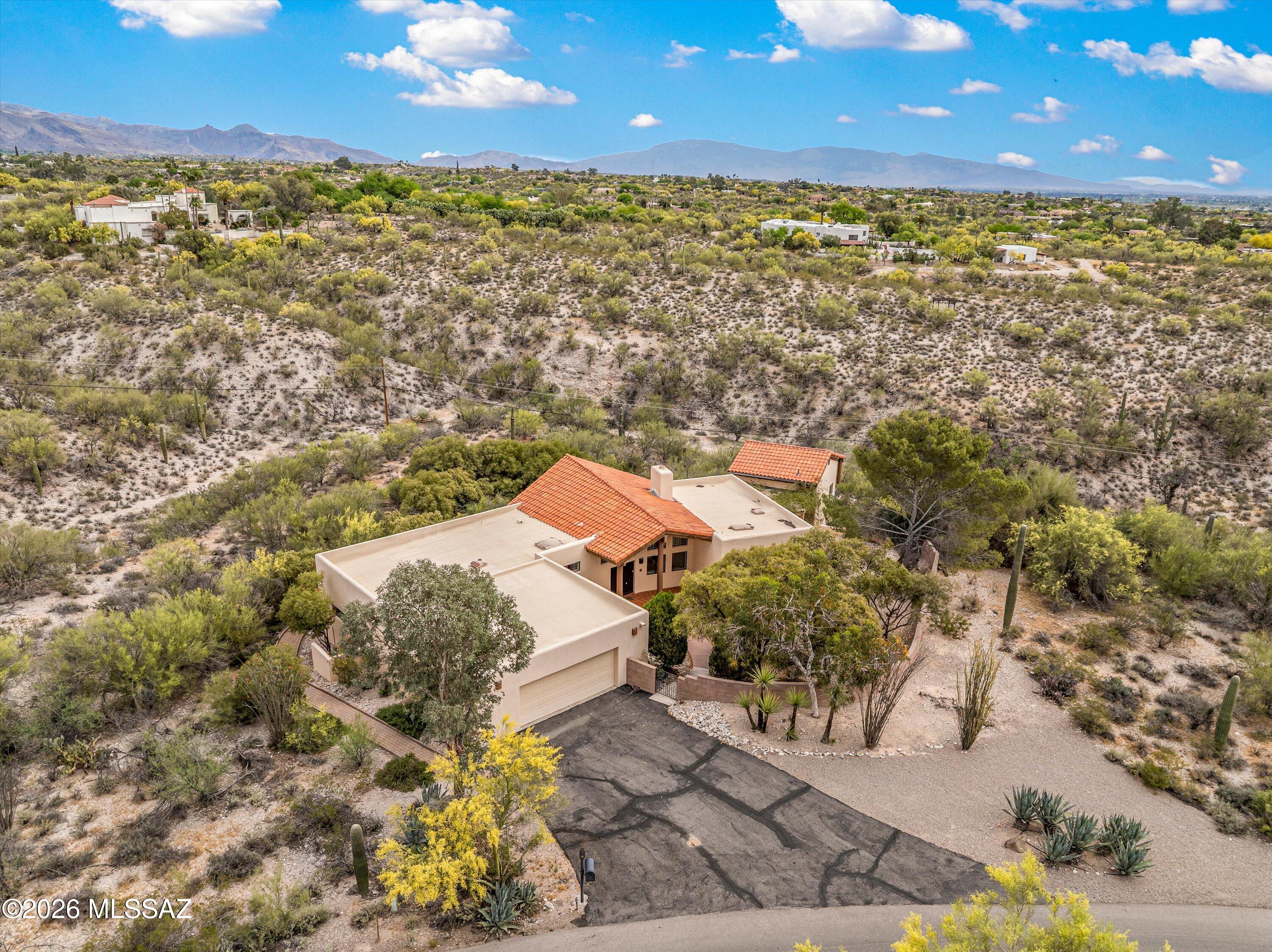 Welcome to a rare opportunity in Tucson's highly sought-after Foothills, located in the desirable 85718 zip code. This stunning property offers a 3-bedroom, 2-bath main residence along with a separate guest quarters/studio--perfect for visitors or a home office.
Set on nearly 2 acres, the home is perfectly positioned to capture breathtaking mountain views from every angle. The great room is a true showstopper, featuring dramatic floor-to-ceiling windows that flood the space with natural light and frame the surrounding landscape like a work of art.
The thoughtfully designed split floor plan provides privacy and functionality, with a spacious primary suite set apart from the additional bedrooms. An oversized garage offers ample space for vehicles, storage, or a workshop. Welcome to a rare opportunity in Tucson's highly sought-after Foothills, located in the desirable 85719 zip code. This stunning property offers a 3-bedroom, 2-bath main residence along with a separate guest quarters/studio--perfect for visitors, a home office, or rental potential.Set on nearly 2 acres, the home is perfectly positioned to capture breathtaking mountain views from every angle. The great room is a true showstopper, featuring dramatic floor-to-ceiling windows that flood the space with natural light and frame the surrounding landscape like a work of art.
The thoughtfully designed split floor plan provides privacy and functionality, with a spacious primary suite set apart from the additional bedrooms. An oversized garage offers ample space for vehicles, storage, or a workshop.
Enjoy the tranquility of desert living with room to roam, entertain, and take in Tucson's iconic sunsets and sunrises--all while being just minutes from city conveniences. This is Foothills living at its finest.