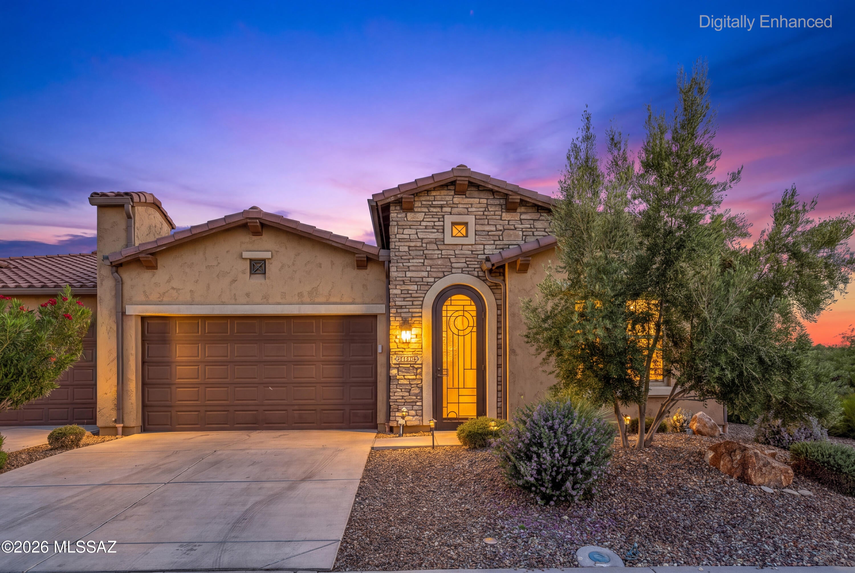 The mountain views here are the real story -- open space, Catalina mountain sightlines, and a covered travertine tile patio that makes sitting outside and soaking it all in that much more comfortable.

Inside, the freshly painted 1,638 sq ft home is clean and move-in ready. Plantation shutters, 8-foot doors with trim upgrade, and a comfortable blend of LVP and carpet carry throughout. The kitchen island's waterfall-edge countertop adds both a design moment and generous workspace -- a detail that earns its place. The 2-bed/2-bath single-level layout lives easily and well.

The two-car garage goes well beyond expectations -- mini-split A/C, epoxy floors, utility sink, instant hot water, water filtration, 220V EV charger-ready, and overhead storage. Whether it's hobbies, projects, or simply a space as comfortable as the home itself, it delivers.

All of it inside the gates of Saddlebrooke Ranch, where resort-style pools, fitness, pickleball, golf, dining, and a full calendar of clubs and activities make the lifestyle as good as the address.
